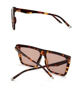 Macro detail of oversized square sunglasses with tortoiseshell pattern and brown lenses