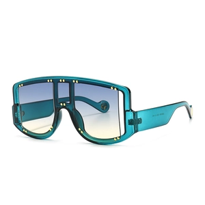 Oversized retro shield sunglasses with gold studs and blue-yellow gradient lenses