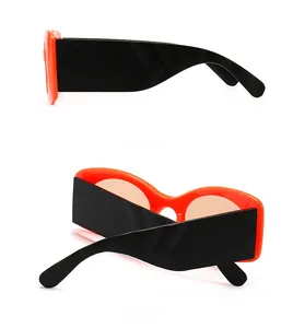 Side and back view of oversized orange sunglasses with wide black temple details