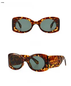 Front and 45-degree side views of leopard green oval sunglasses with dark lenses