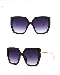 Front and side view of black oversized sunglasses with gradient lenses and gold metal arms