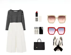 Flat lay of vintage oversized sunglasses with striped top and fashion accessories