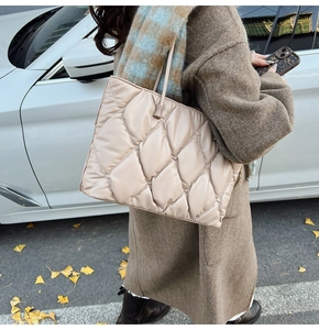 Chic beige quilted tote bag showing large capacity and soft rhombus texture in outdoor setting