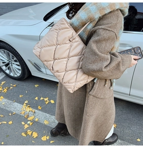 Chic beige quilted puffer tote bag shown in an autumn street setting with a large capacity