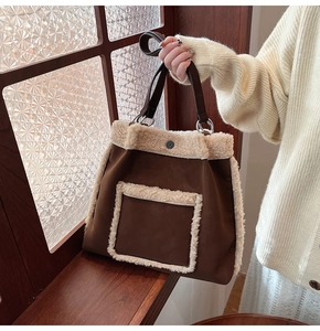 Detail of faux suede tote bag featuring plush faux fur trim and vintage metal ring handles