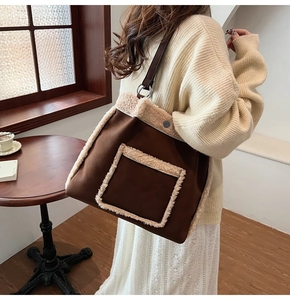 Detail of a brown tote bag featuring plush faux fur trim and front pocket accents