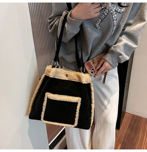 Detail of soft plush faux fur trim on black autumn tote bag with front pocket