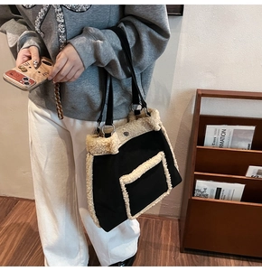 Detail of black faux fur tote bag with white lamb wool trim and silver metal ring
