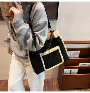 Detailed view of the black canvas bucket bag featuring soft white lamb wool trimming and edges
