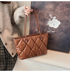 Close-up of deep brown quilted tote bag showing high-quality faux leather and fine stitching