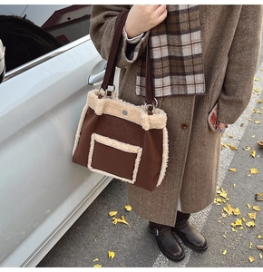 Detail of faux shearling trim on a large brown tote bag for autumn and winter outfits