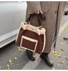 Brown wool-trimmed tote bag close-up on autumn street with ginkgo leaves background