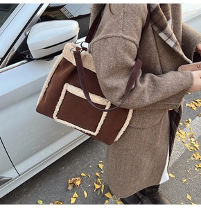 Detail of suede tote bag with faux shearling trim and long leather shoulder straps