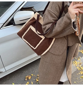 Detail of coffee brown faux suede tote with white faux fur trim in autumn street style