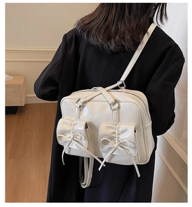 White glossy backpack with bow details shown on a model for a sweet, preppy look