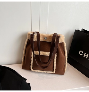 Detail of brown faux suede tote bag with cream sherpa trim and dark PU shoulder strap