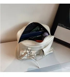 Interior view of ballet style bow shoulder bag showing large storage capacity