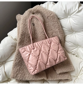 Close-up of quilted light pink tote bag on brown fleece texture for autumn vibes