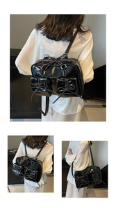Detail of black ballet-style shoulder bag featuring ribbon bows and functional pockets
