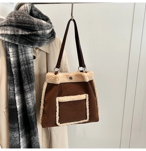 Detailed view of plush tote bag with brown suede and white faux fur trim on a coat hanger