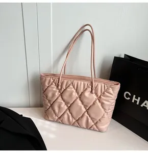 Close-up of quilted tote bag in pale pink PU leather with refined stitching texture