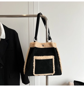 Detail of suede tote bag with contrast cream faux fur trim and front pocket
