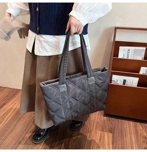 Detailed close-up of charcoal gray quilted nylon tote bag with large capacity and stitch work