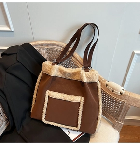 Close-up of brown suede tote bag with white fleece trim and front pocket details