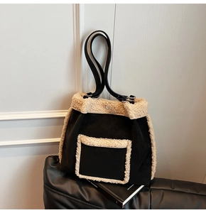 Detail of black tote bag with plush sherpa fleece trim and front pocket contrast