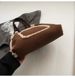 Detail of retro faux shearling brown tote bag on grey blazer for autumn outfit style