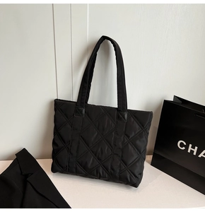 Detailed view of the black quilted puffer tote bag with premium diamond stitching pattern