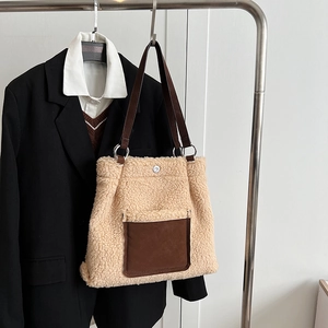Detail of plush lamb wool tote bag with brown suede pocket and leather shoulder strap