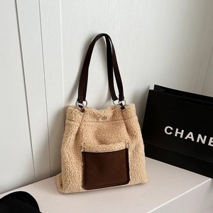Detail of lambskin tote bag showing magnetic clasp closure and premium plush texture