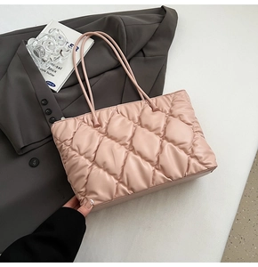Close-up of pink quilted tote bag showing fine faux leather texture and elegant stitching