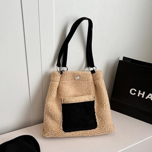 Detail of plush fleece tote bag with black front pocket and silver metal ring hardware