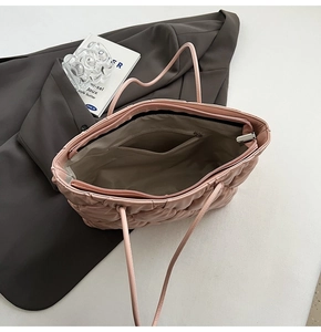 Pink quilted tote bag with spacious interior compartment and secure zipper closure