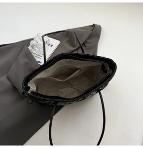 Detail view of the quilted tote bag interior with gray lining and zipper pocket