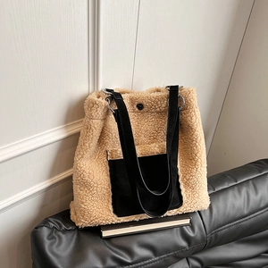 Detail of plush lamb wool tote bag with black leather pocket and long shoulder straps