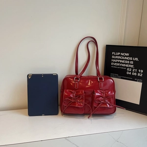 Red patent leather shoulder bag with bow detail and large capacity for daily commuting