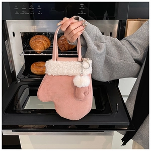 Pink oven mitt shaped bucket bag with faux fur trim shown in a kitchen setting