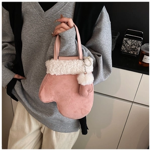 Pink mitten-shaped crossbody bag with soft white faux fur trim and cute heart charms