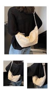 Macro detail of creamy white dumplings bag featuring elegant diagonal stitching seams