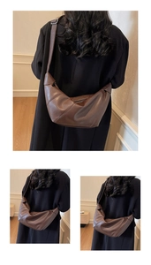 Detail of dark brown leather crossbody bag in dumpling shape with wide shoulder strap