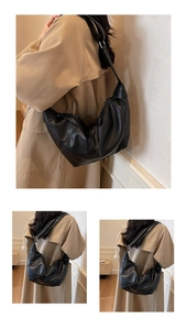 Detail shot of the large black leather crescent hobo bag with wide shoulder strap