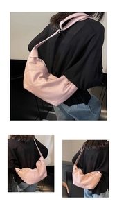 Detail of pink hobo bag featuring soft leather texture and elegant pleated design