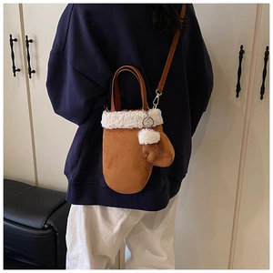 Glove-shaped faux suede crossbody bag with plush white fur trim and a decorative pom-pom