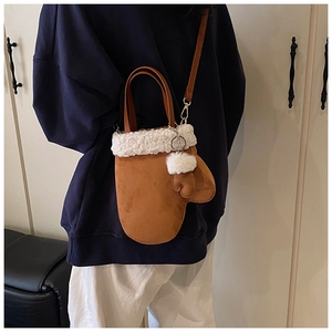 Detail of glove-shaped crossbody bag with brown suede and white fleece trim