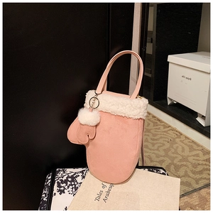 Detail of pink suede bucket bag featuring white faux fur trim and cute glove charm
