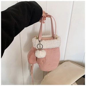 Detail of pink mitten-shaped bag with white faux fur trim and gold hardware accents