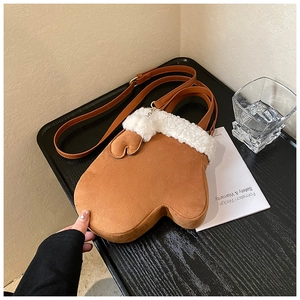 Close-up of brown mitten-shaped crossbody bag with soft white faux shearling trim